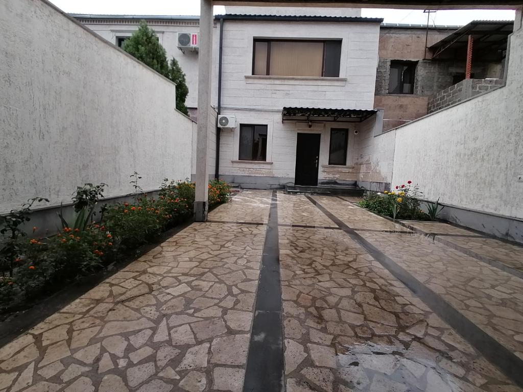 a stone walkway in front of a building at OUR House in Vagharshapat