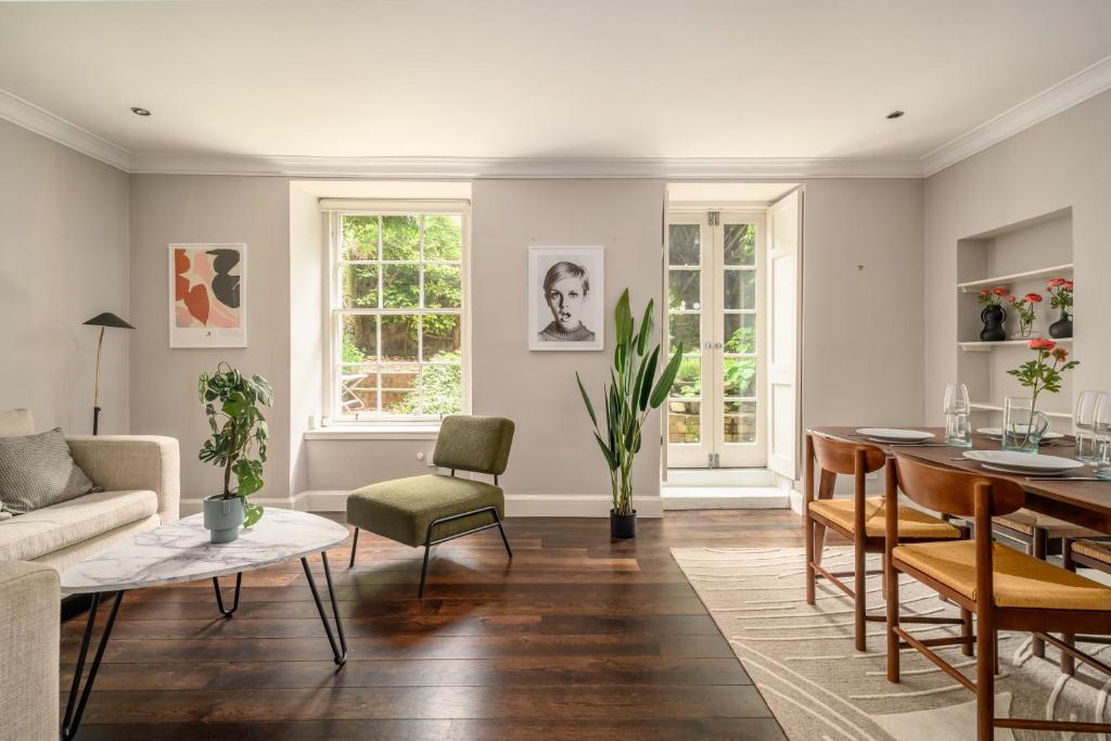 a living room with a couch and a table at Retro New Town Garden Flat in Edinburgh
