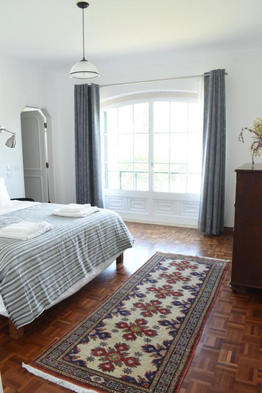 - une chambre avec un lit et une grande fenêtre dans l'établissement Ericeira Living, à Ericeira