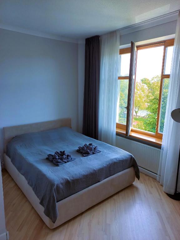 a bedroom with a bed and a large window at Great View Studio, self check in, free parking in Klaipėda