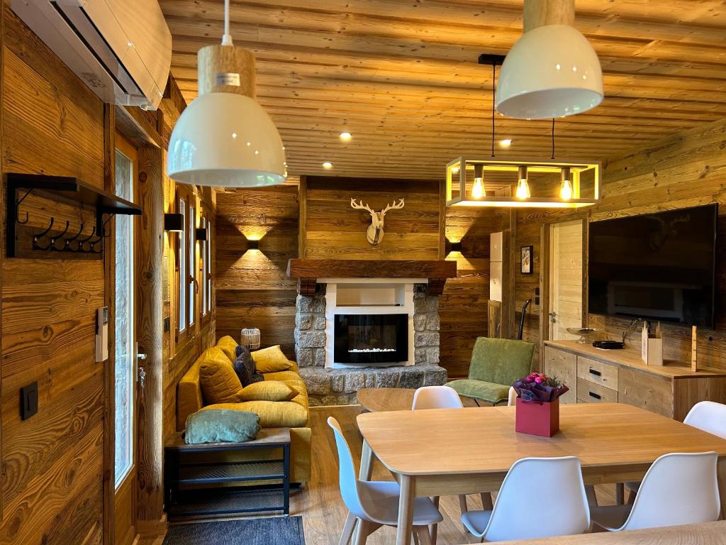 a dining room with a table and a fireplace at Le cerf majestueux, Bolquere in Bolquere Pyrenees 2000