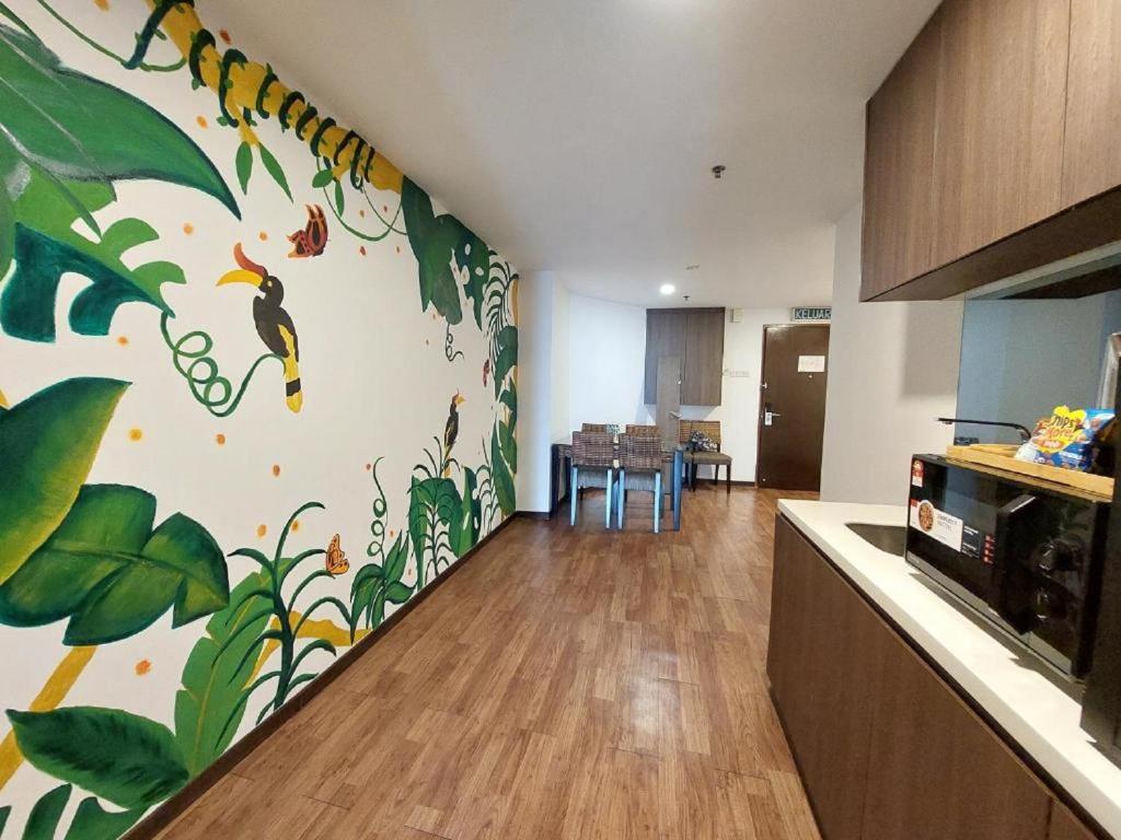 a kitchen with a wall with a peacock mural at Townhouse OAK 591 Shah Alam By Salaam Suites in Shah Alam