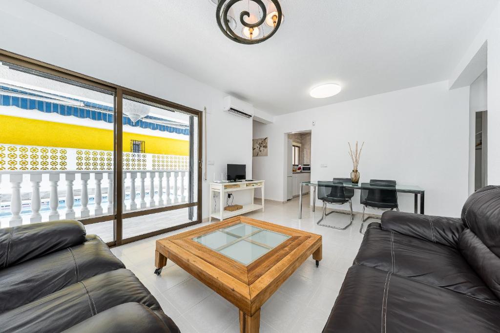 a living room with a couch and a coffee table at Chalet Villasol Con Piscina in Alicante