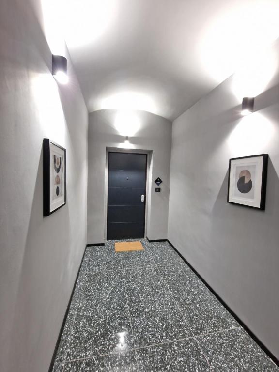 a hallway with a door and two pictures on the wall at Casa Sobit in Turin