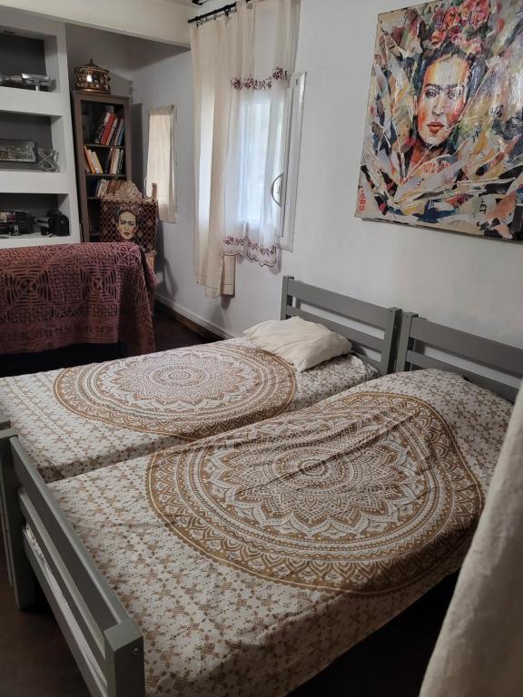 Duas camas num quarto com um quadro na parede em Le toit du monde em Ceyreste