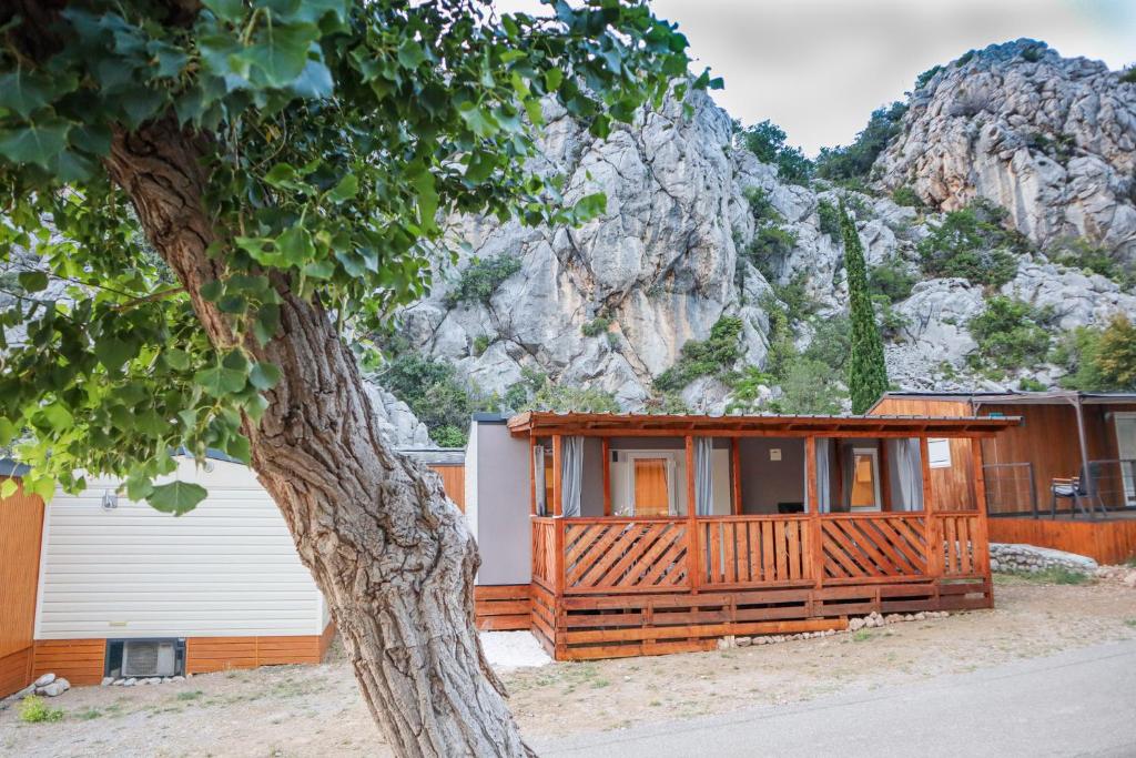 a house in front of a mountain at Mobile home MARIS in Sveti Juraj