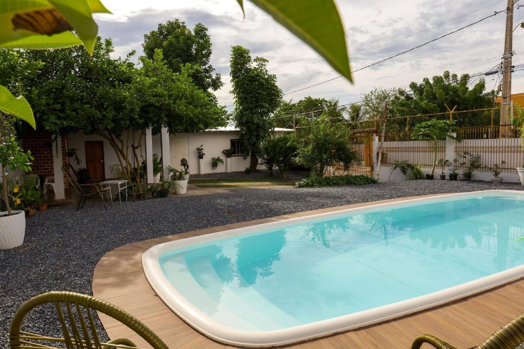 a large swimming pool sitting next to a house at Pousada dos Ventos Refugio Urbano in Cuiabá