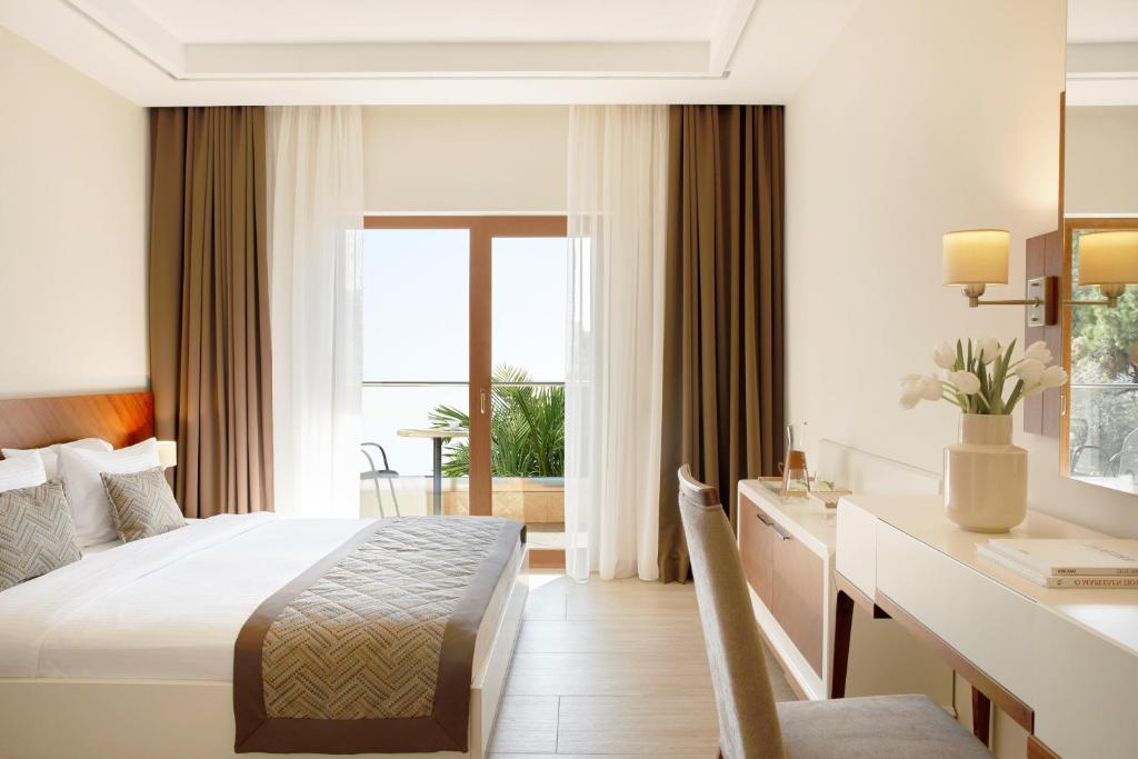 A bed or beds in a room at Potidea Palace Hotel