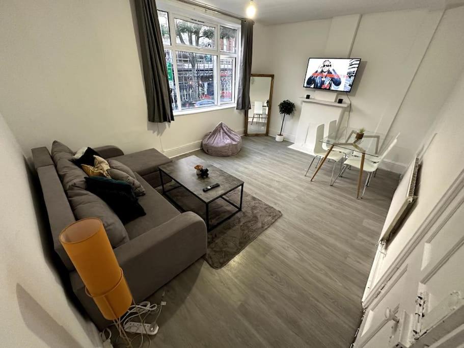 a living room with a couch and a table at Spectacular 2 bedroom on Tower Bridge in London