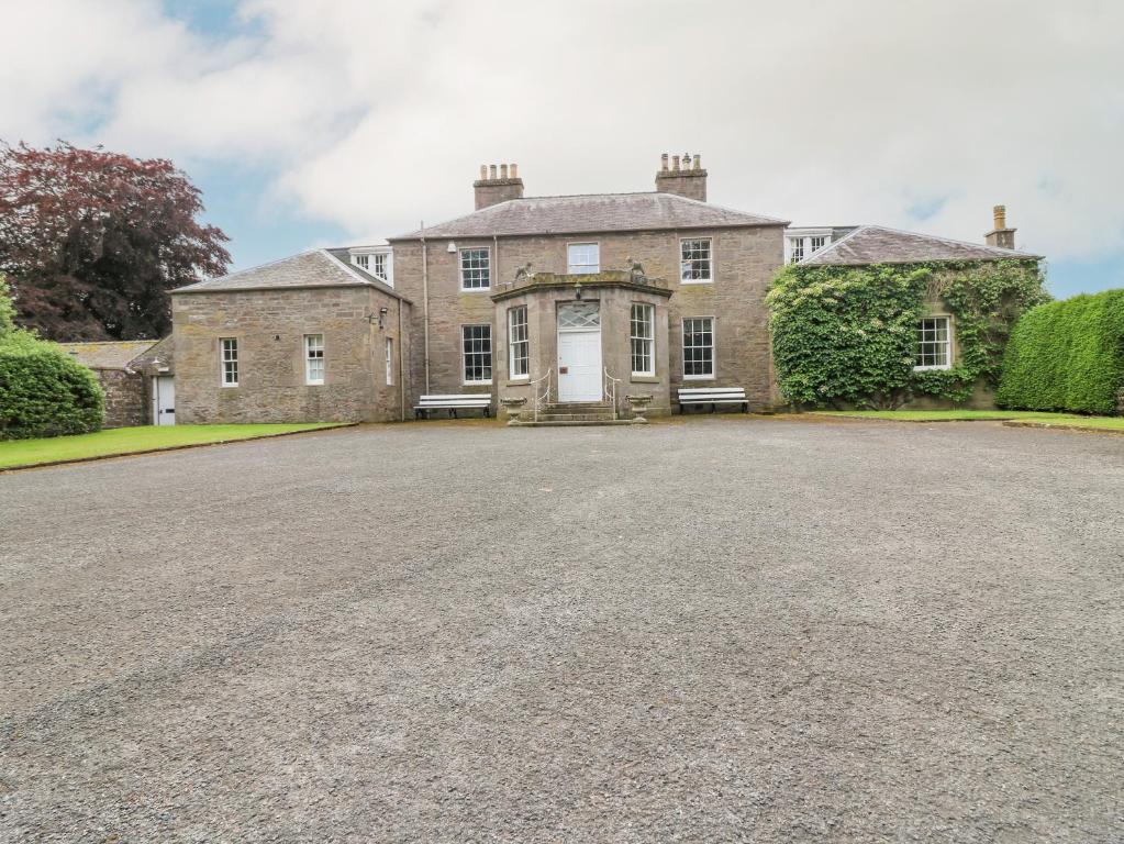 a large brick house with a large driveway at Glamis House in Forfar