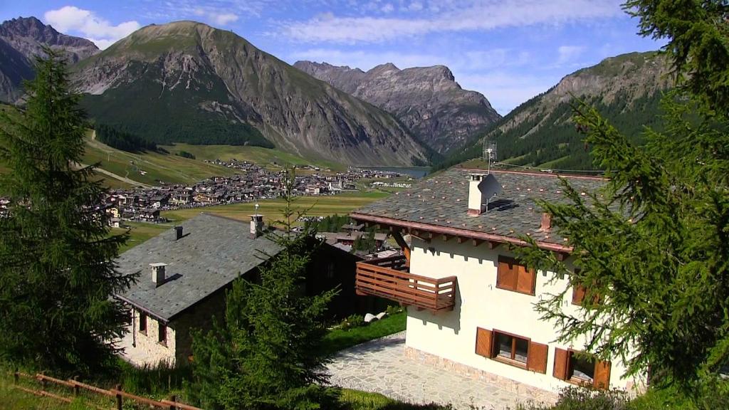 a village in a valley with mountains in the background at Chalet Elena in Livigno