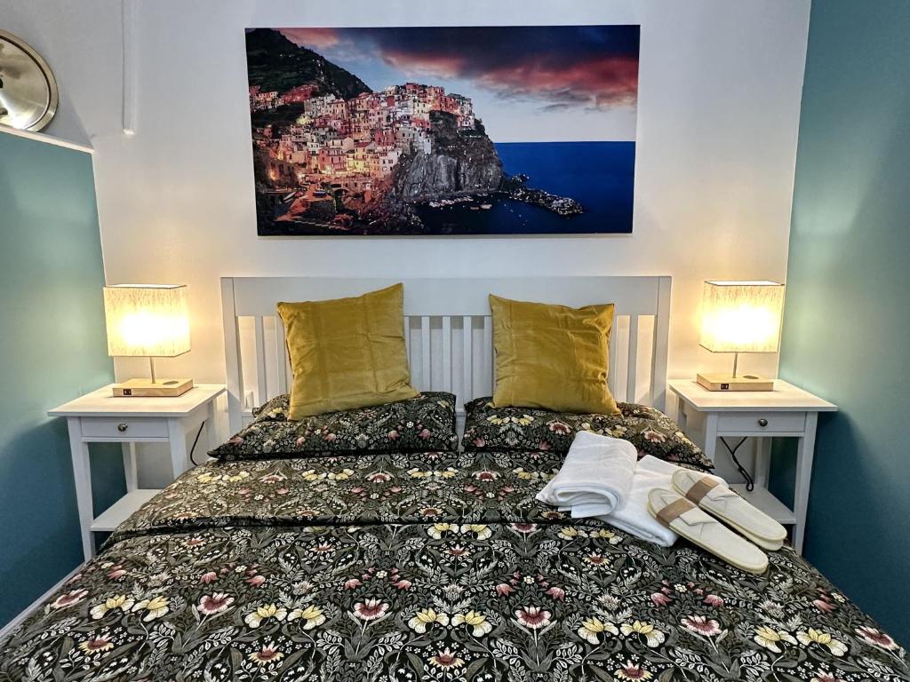 a bedroom with a bed with two lamps on it at Aquarium Exclusive Loft - Free Parking in Genoa