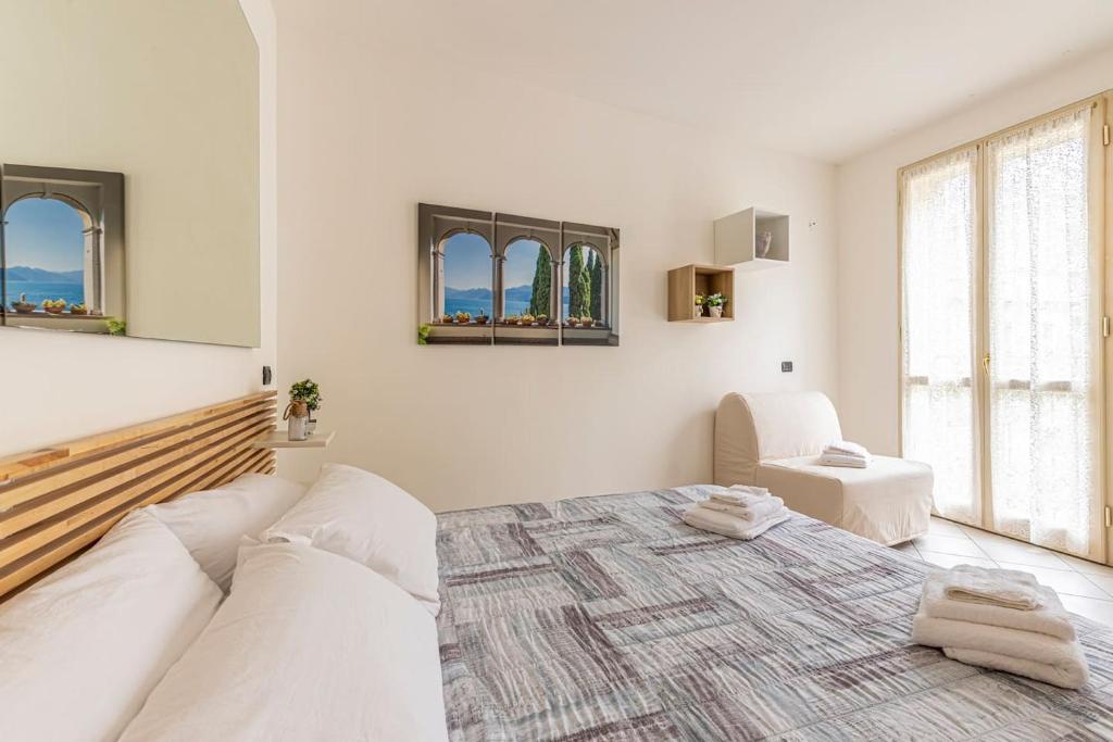 萊科的住宿－[Lago di Como] Lecco Centro - 1’ da lago/stazione，白色的客房设有床和窗户。