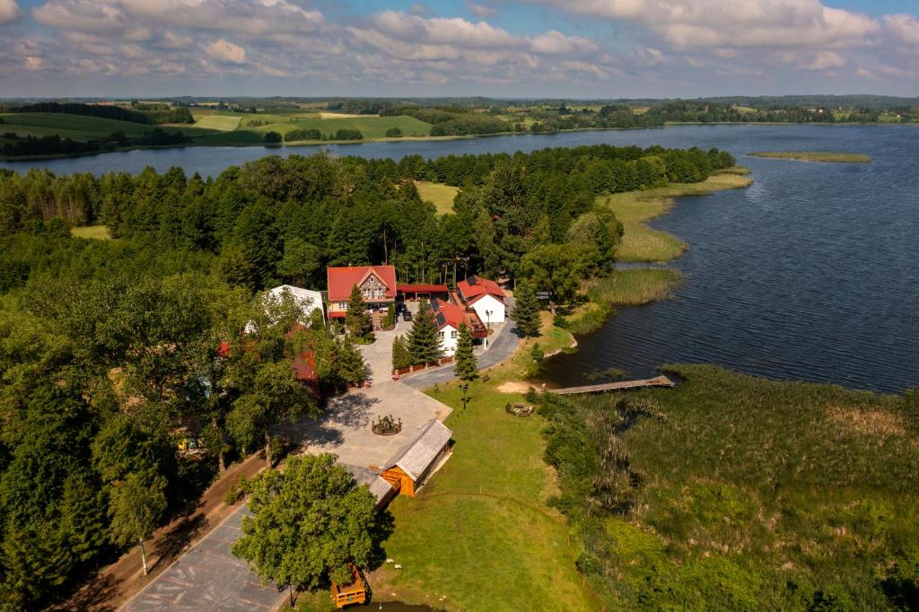 an aerial view of a house on the shore of a lake at Agroturystyka Kalinka in Wiżajny