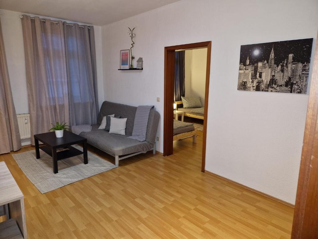 sala de estar con sofá y mesa en Monteurwohnung Zwickauer Land en Crimmitschau