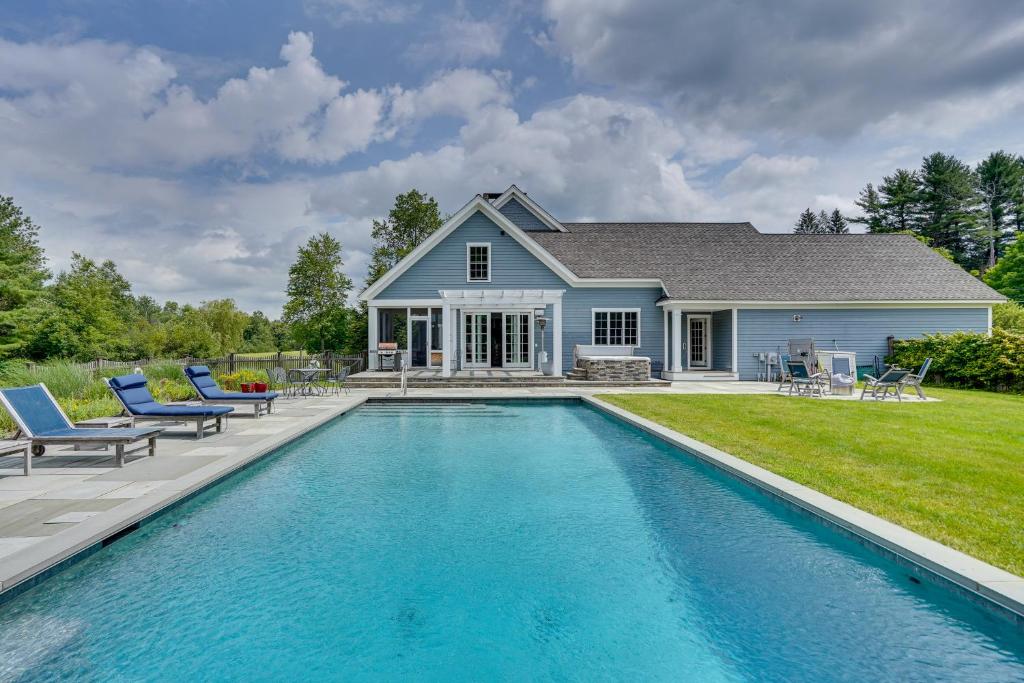 a house with a swimming pool in front of a house at Stockbridge Retreat with Pool and Hot Tub! in Stockbridge