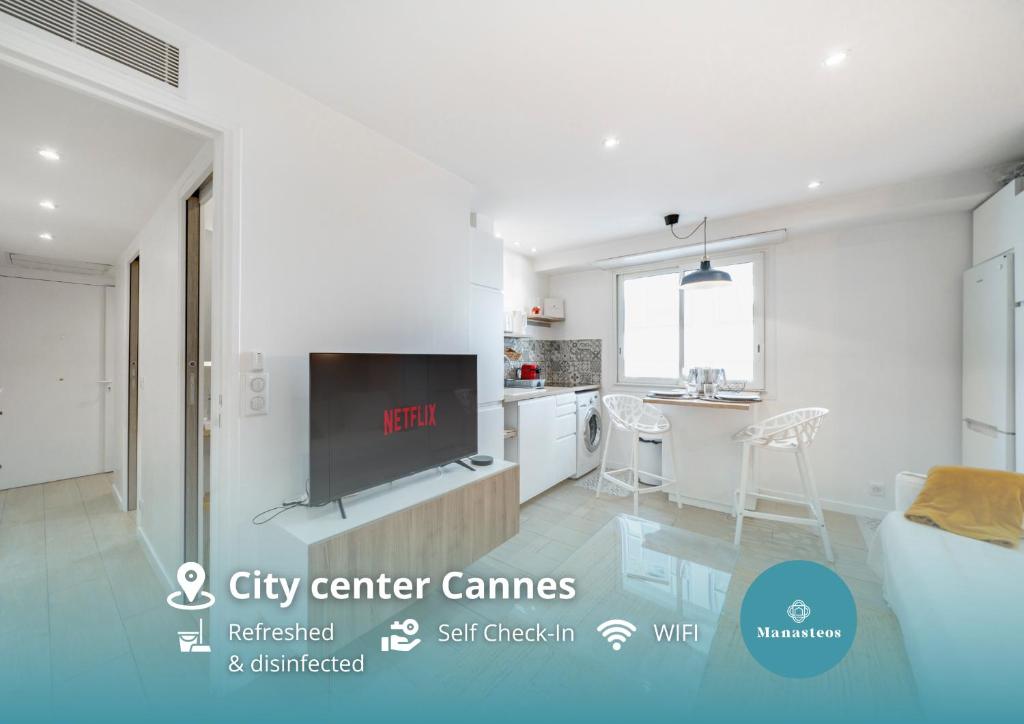 a living room with a tv and a kitchen at Cannes Centre - 10mn Palais, Plages, Croisette - AT in Cannes