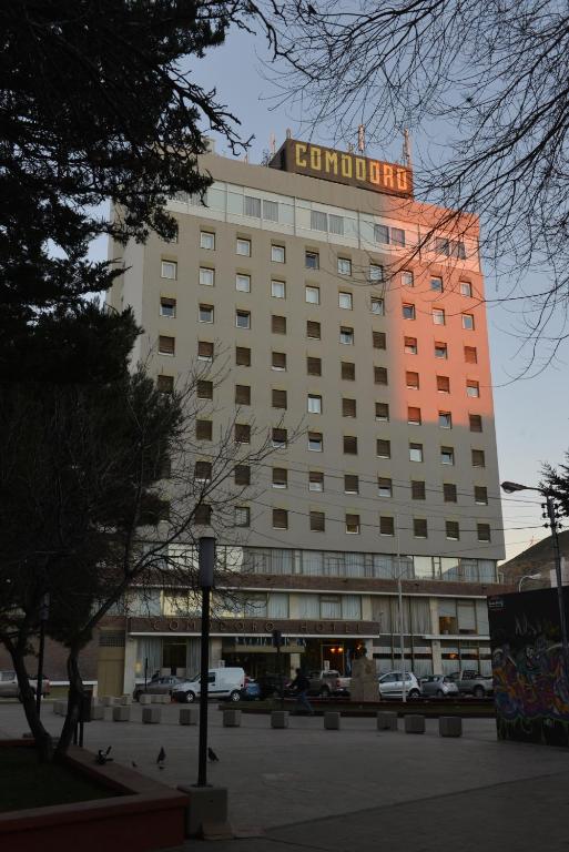 a building with a sign on the top of it at Comodoro Hotel in Comodoro Rivadavia
