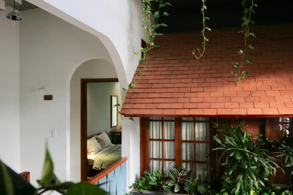 a house with a red roof and a bedroom at Nhà bình Homestay in Da Nang