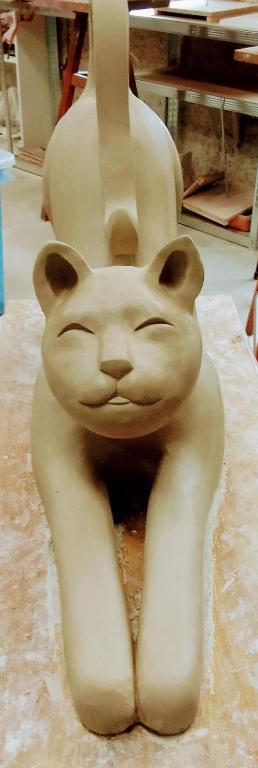 a statue of a white cat sitting on a table at L&#39;Orangerie White-Palacio in Versailles