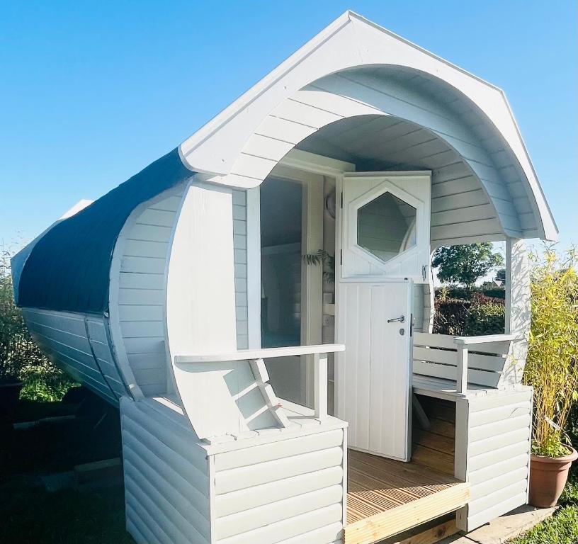 una casa de juegos blanca con una puerta abierta en Charming Lodge in Morpeth, en Morpeth