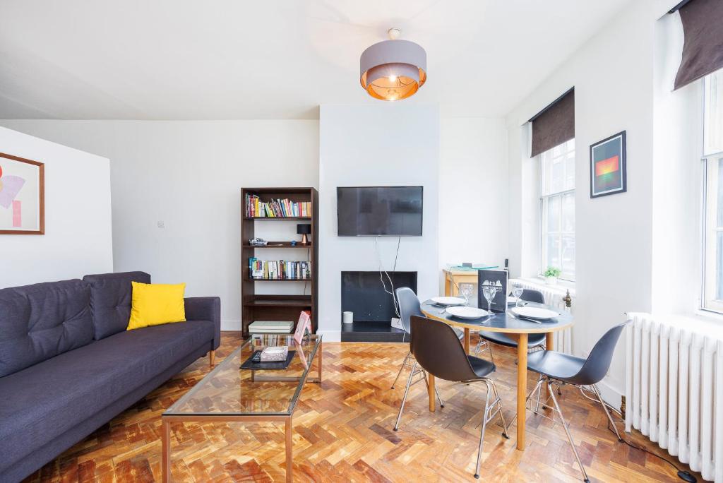 a living room with a couch and a table at Dynamic in Dean Street in London