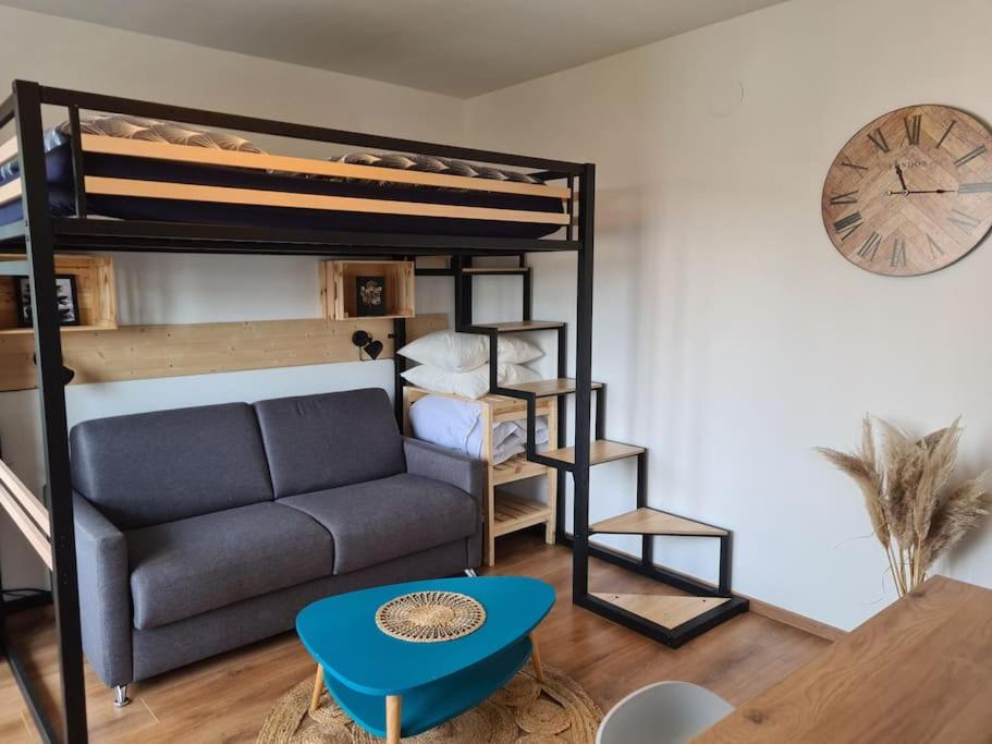 a living room with a couch and a bunk bed at Studio cosy et lumineux bike parking in Saverne