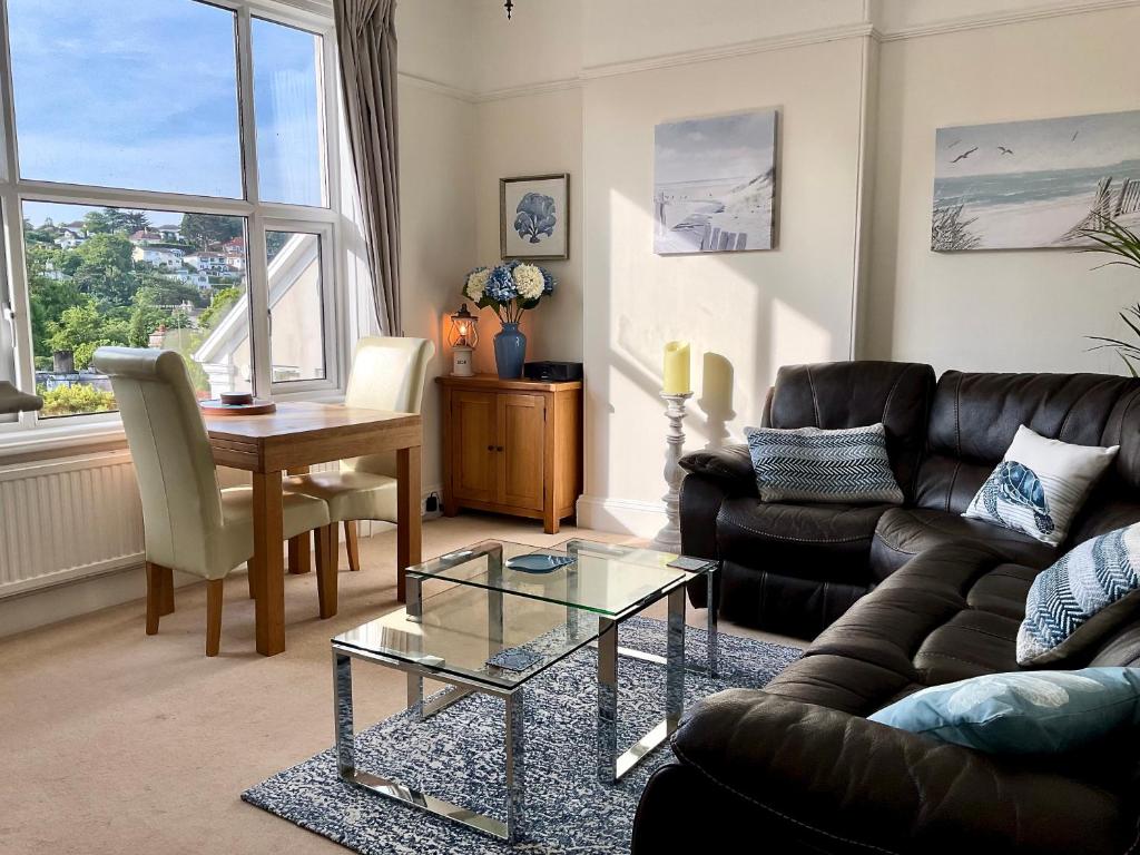 a living room with a couch and a table at The KinBrae Apartment in Torquay