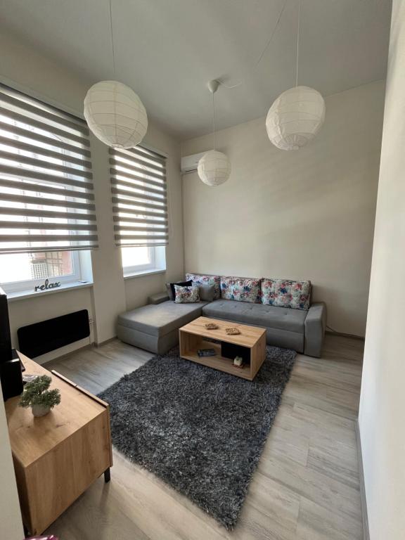 a living room with a couch and a table at The City Block - Free Parking in Sarajevo