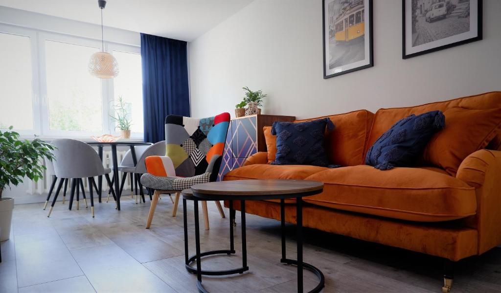 a living room with a couch and a table at APARTAMENT "Opawska Przystań" in Głuchołazy