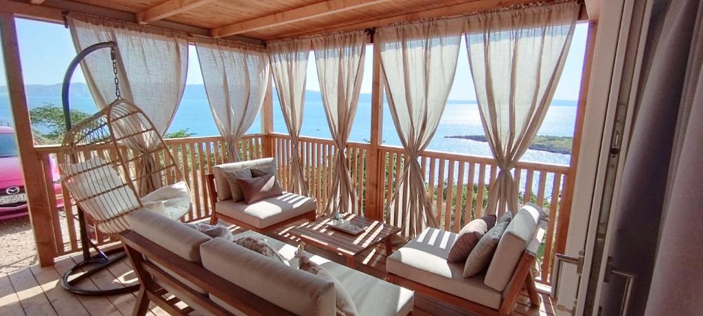 a room with a balcony with a view of the ocean at Mobile home Greta in Klenovica