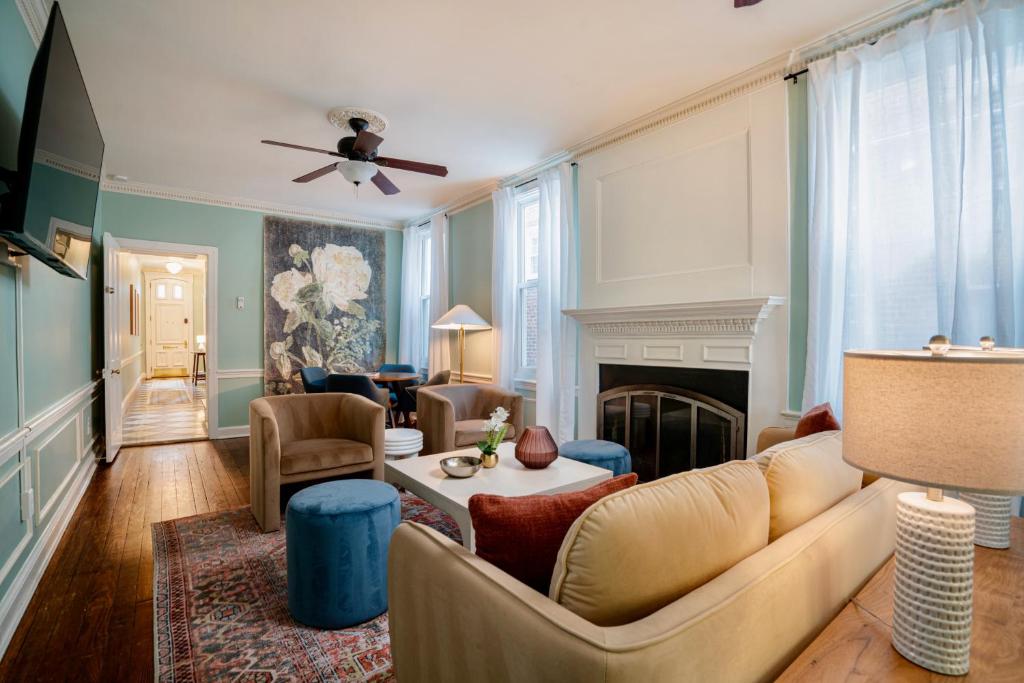 a living room with a couch and a fireplace at The W House Traveler's Dream Heart of Old Town in Alexandria
