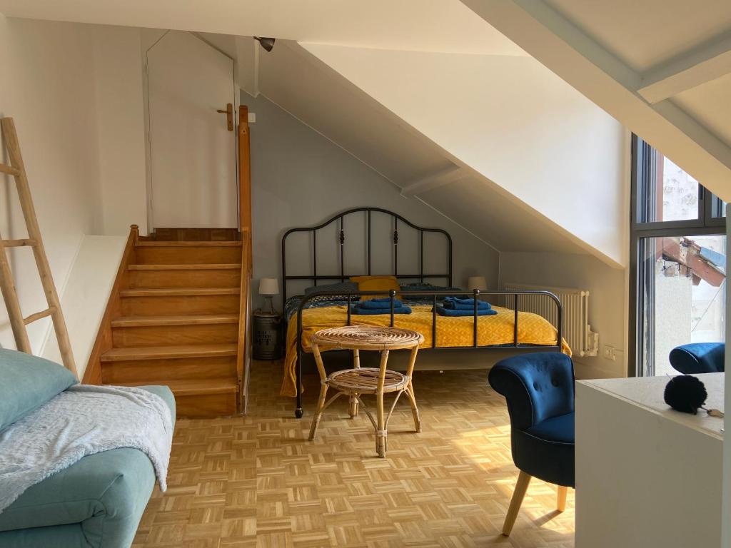 a bedroom with a bed and a table and chairs at La LocaLuna in Civray-de-Touraine