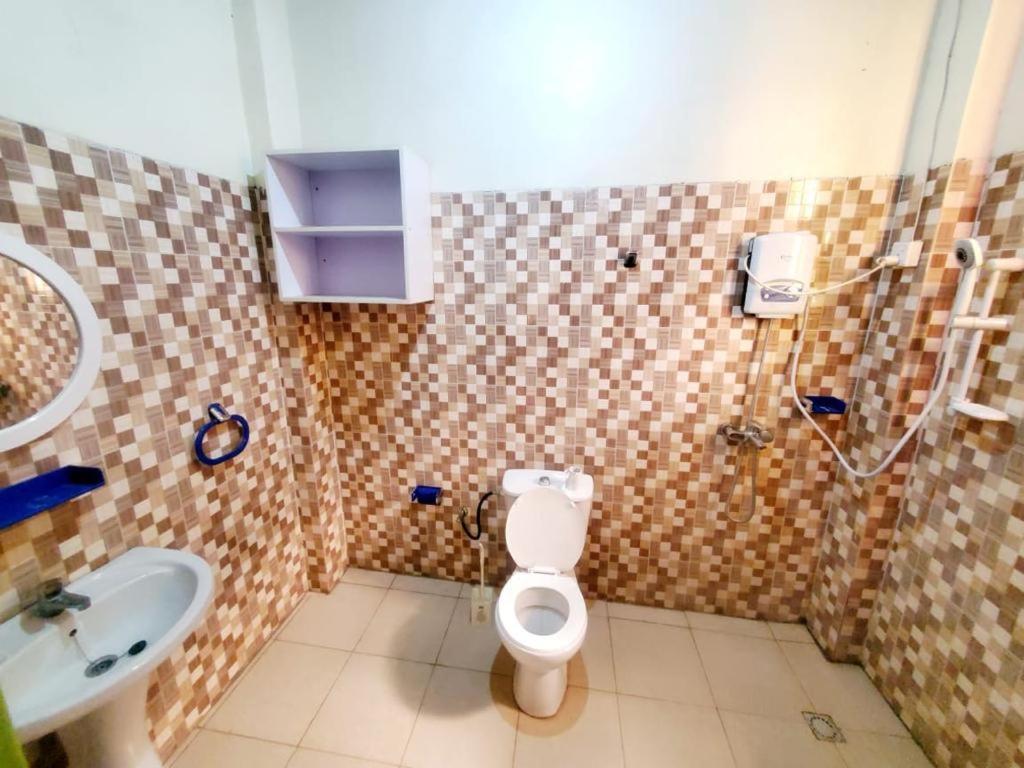 a bathroom with a toilet and a sink at TWINS VILLA SUITES KIGALI in Kigali