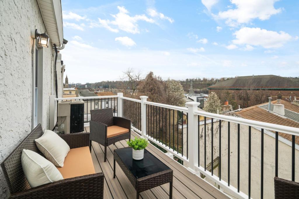 a balcony with a table and chairs on a building at Brand New Manayunk Retreat 2BR including parking in Philadelphia