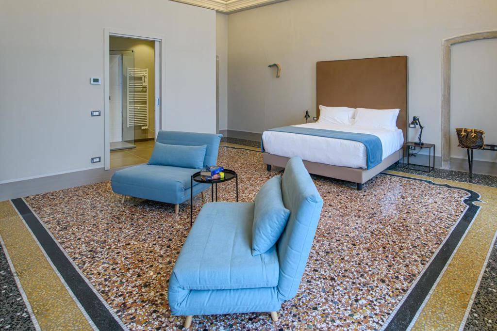 Posteľ alebo postele v izbe v ubytovaní Palazzo Sertorio Suites