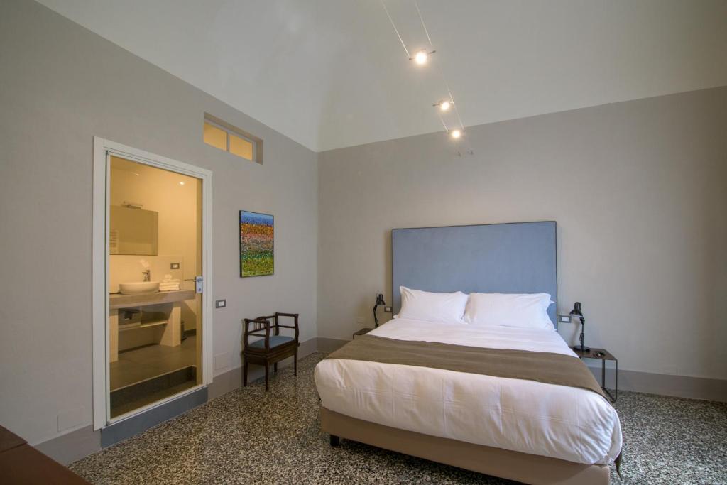 Posteľ alebo postele v izbe v ubytovaní Palazzo Sertorio Suites
