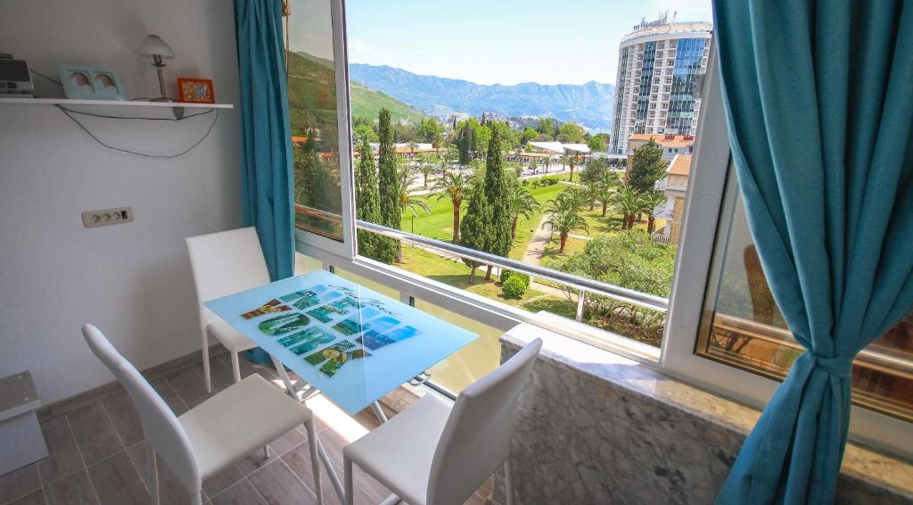 a room with a table and chairs and a large window at Irena Downtown Apartment in Budva