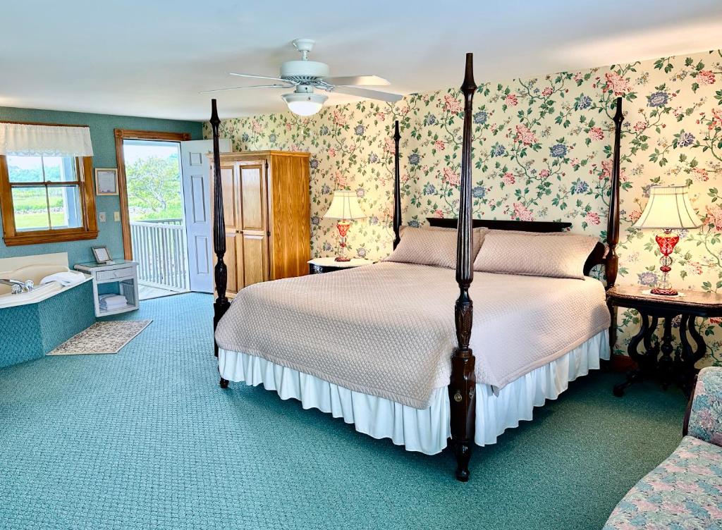 a bedroom with a bed and floral wallpaper at Rose Farm Inn in New Shoreham