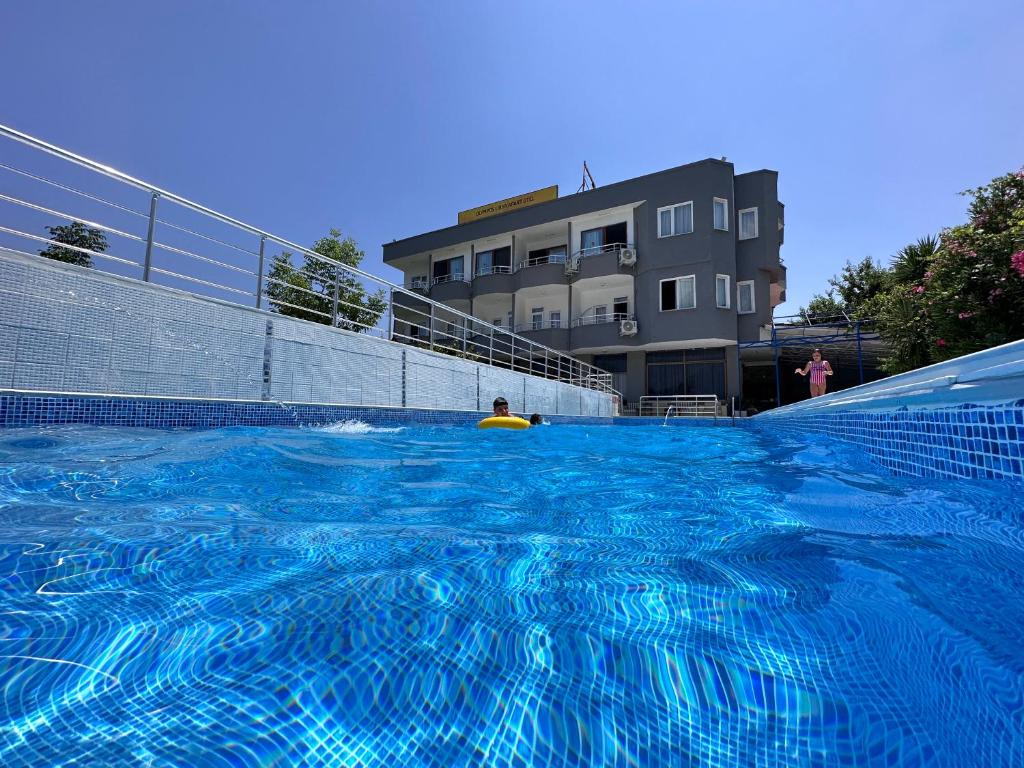 a person in a large blue swimming pool at Olympos Likya Apart Otel in Kumluca