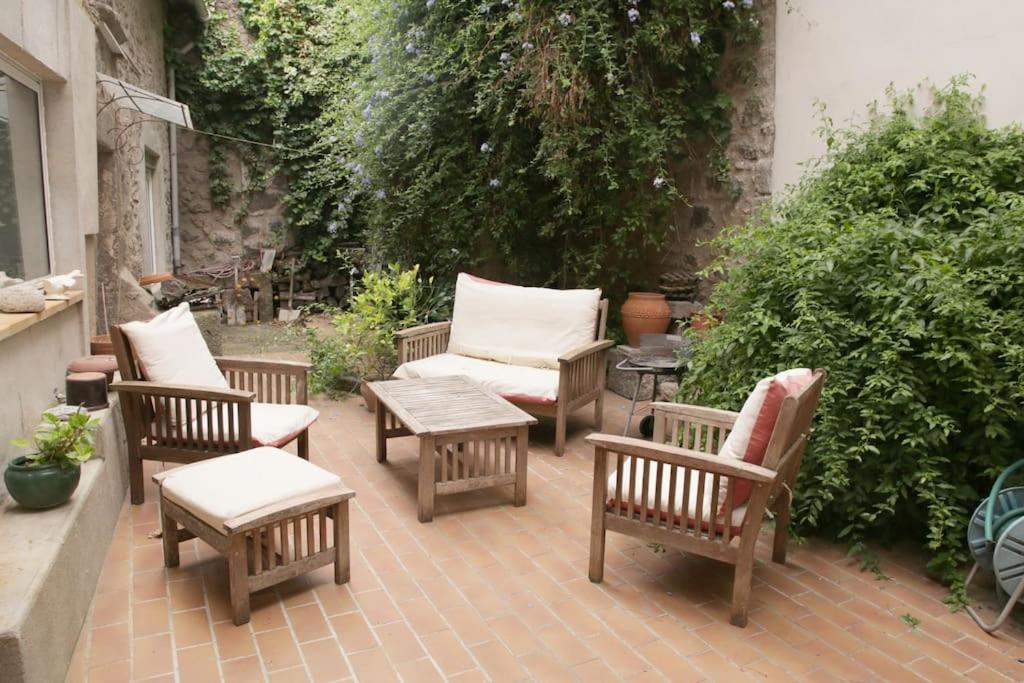 a patio with a group of chairs and a table at Maison avec jardin centre historique in Agde