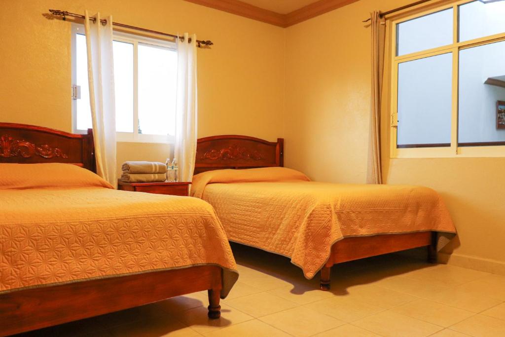 Voodi või voodid majutusasutuse Hotel Coroneo toas