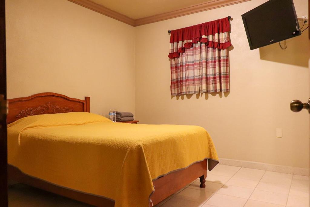 Voodi või voodid majutusasutuse Hotel Coroneo toas