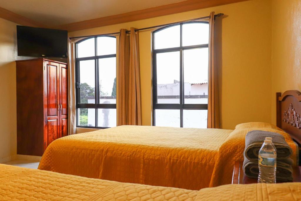 Voodi või voodid majutusasutuse Hotel Coroneo toas