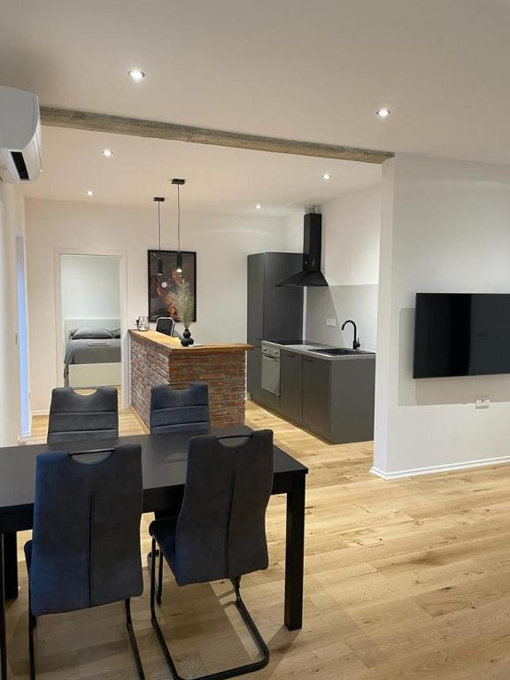 a kitchen and dining room with a table and chairs at AEGIDA BEACHFRONT apartment in Koper