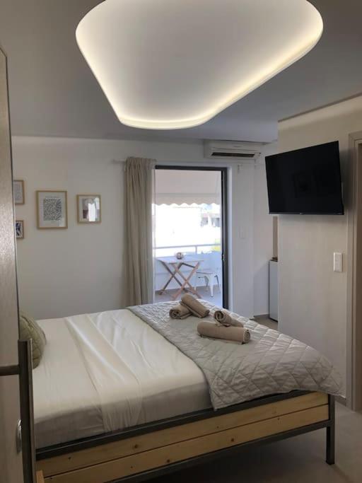 a bedroom with a bed with two towels on it at Anastasia Suite/byArtistUnknown in Vari
