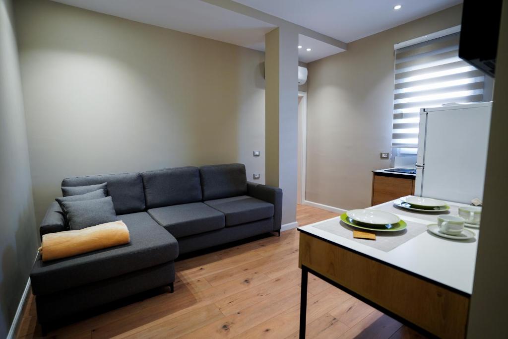 a living room with a couch and a table at Klei’s Daily Apartment in Tirana