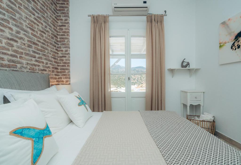 A bed or beds in a room at Erifili Houses