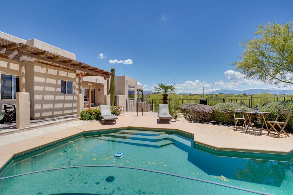 a swimming pool in front of a house at Updated Tucson Home with Panoramic Mtn Views and Pool! in Tucson