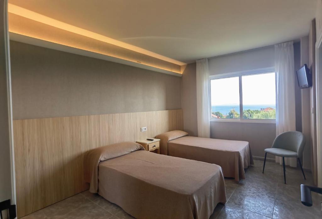 A bed or beds in a room at Pensión Residencia Cecilia